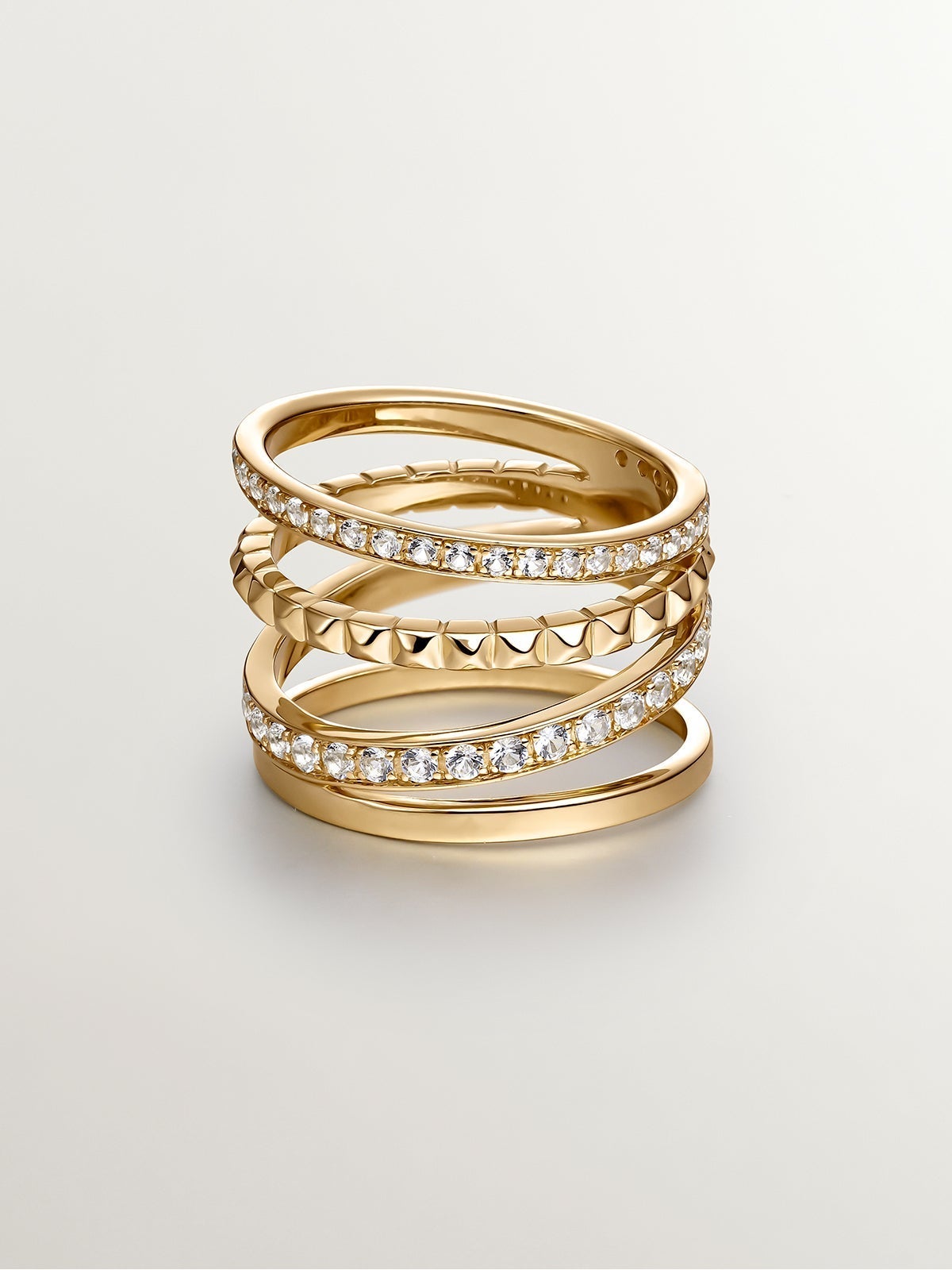 Anillo multibrazo de plata 925 bañada en oro amarillo de 18K con relieve y topacios blancos