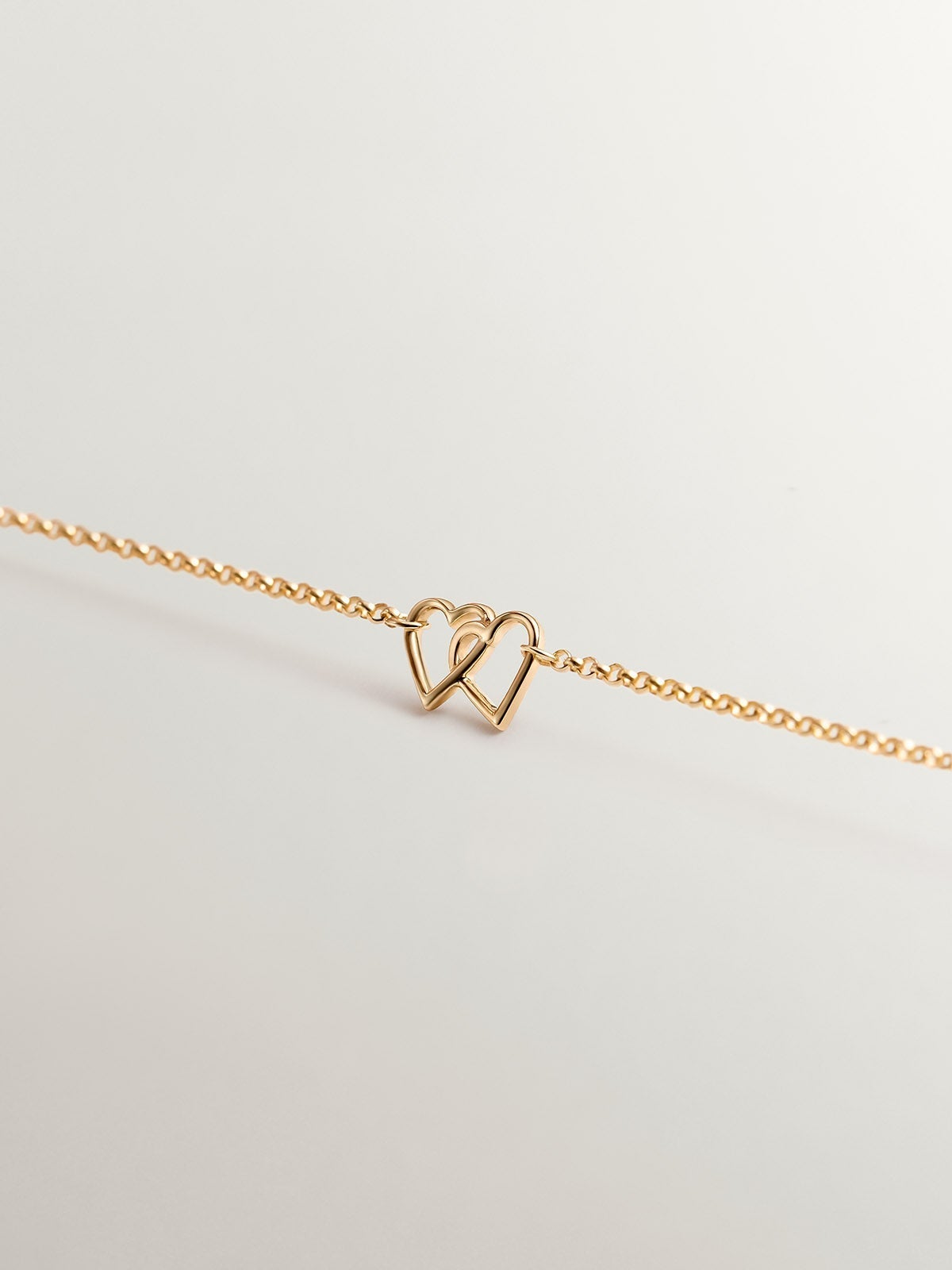 Pulsera de oro amarillo de 9K con corazones entrelazados