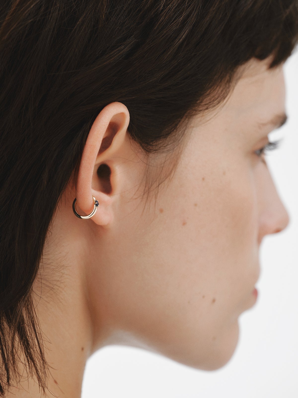 Pendiente de aro individual de oro amarillo de 9K con zafiro azul