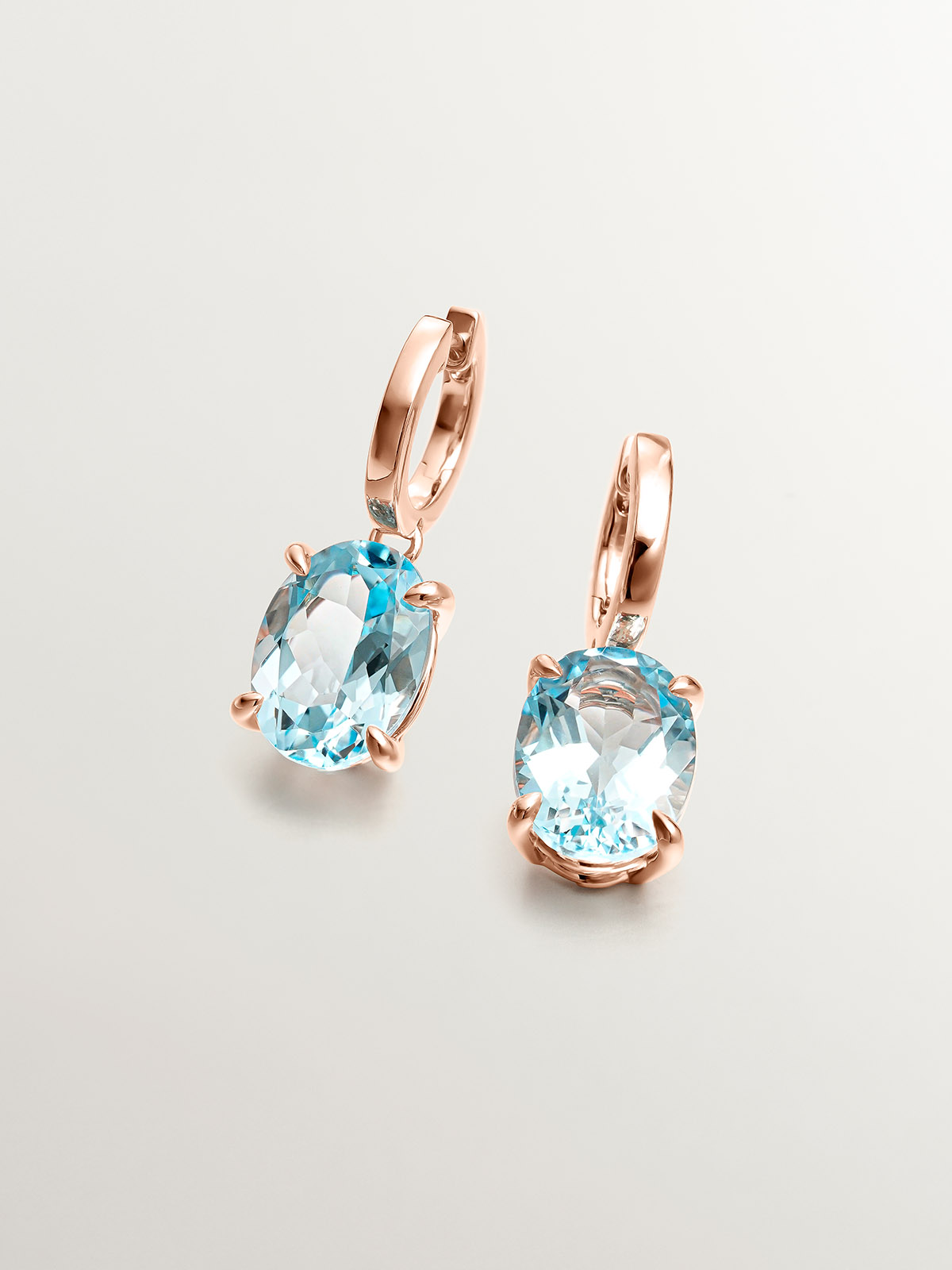 Large hoop earrings made of 925 silver plated in 18K rose gold with sky blue topaz.