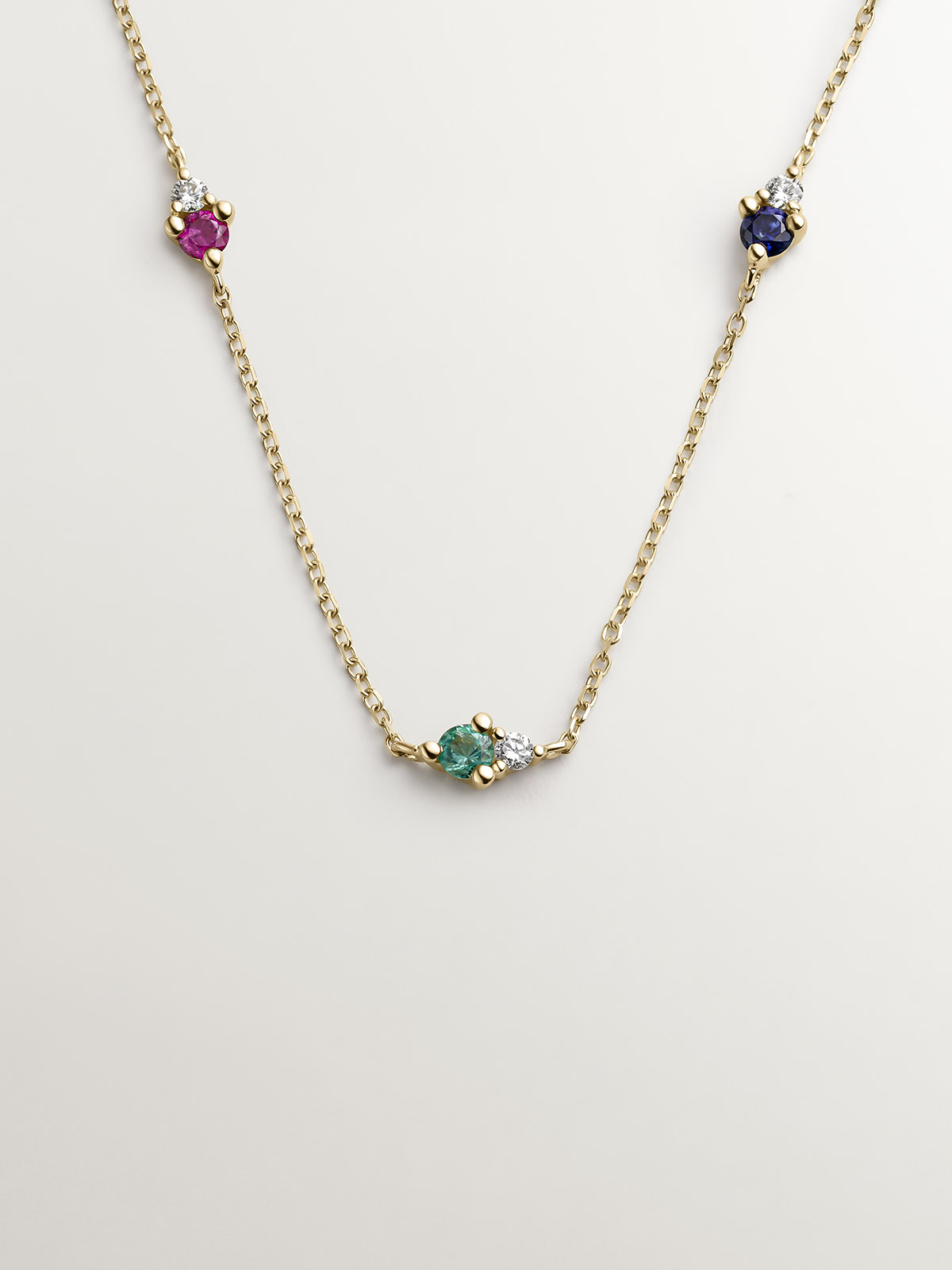9K yellow gold necklace with sapphire, emerald, ruby, and diamonds.