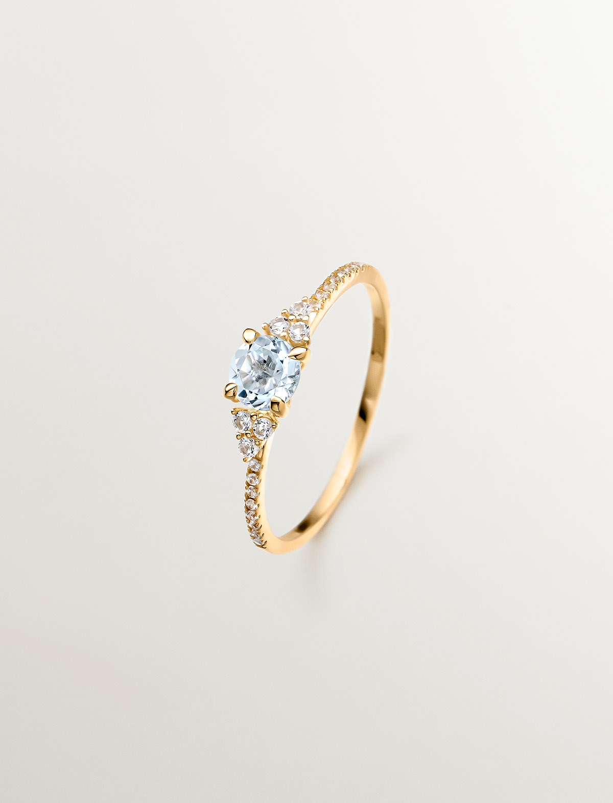 925 Silver ring bathed in 18K yellow gold with sky blue topaz and white sapphires.