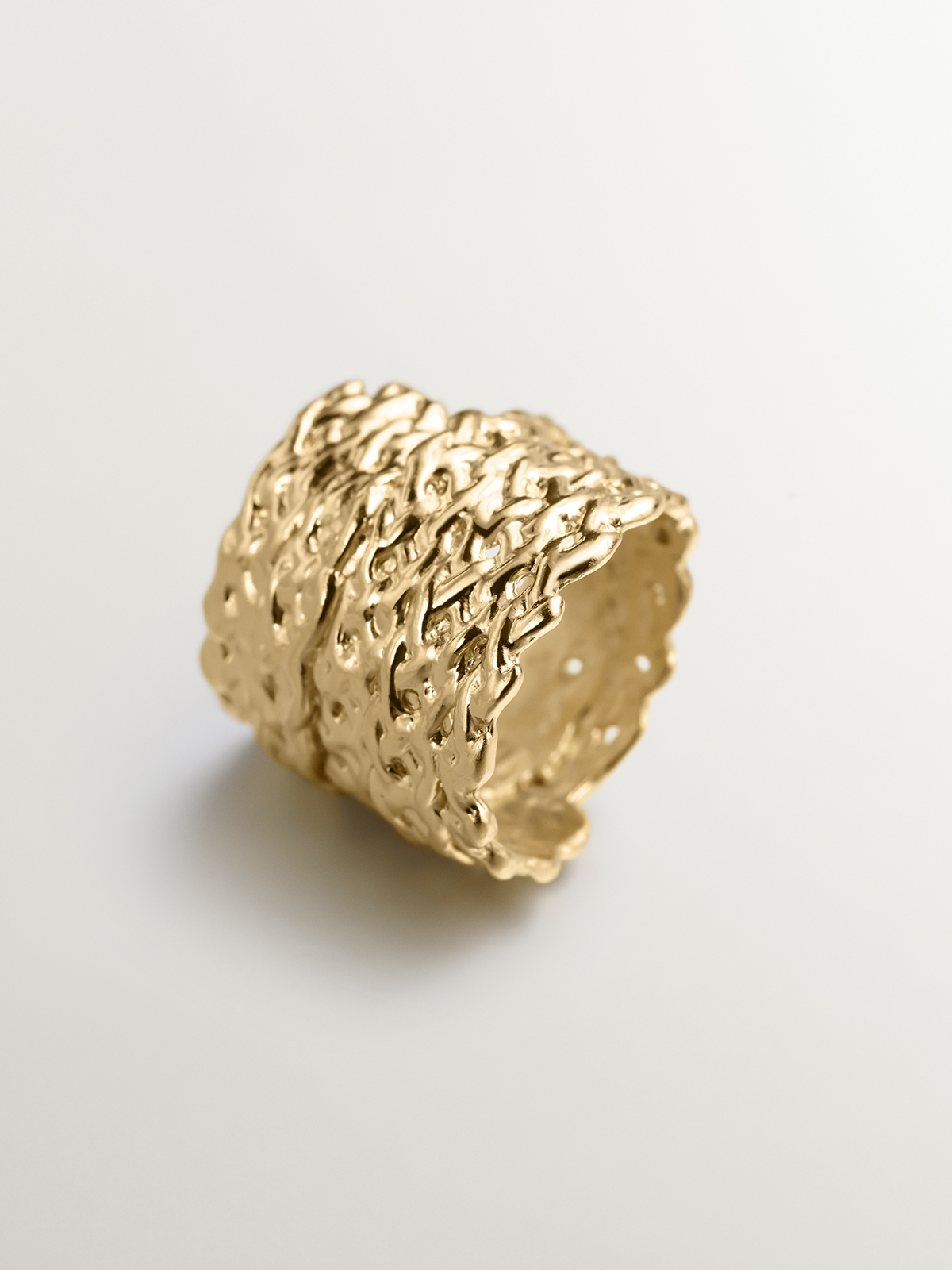 Wide 925 silver ring bathed in 18k yellow gold with wicker texture.