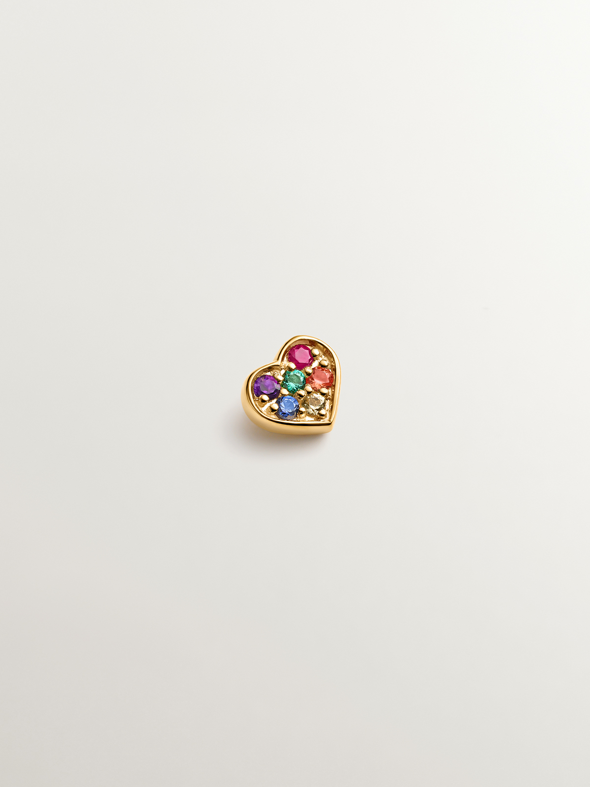 18K yellow gold piercing with emerald, ruby, and multicolor sapphires shaped like a heart.
