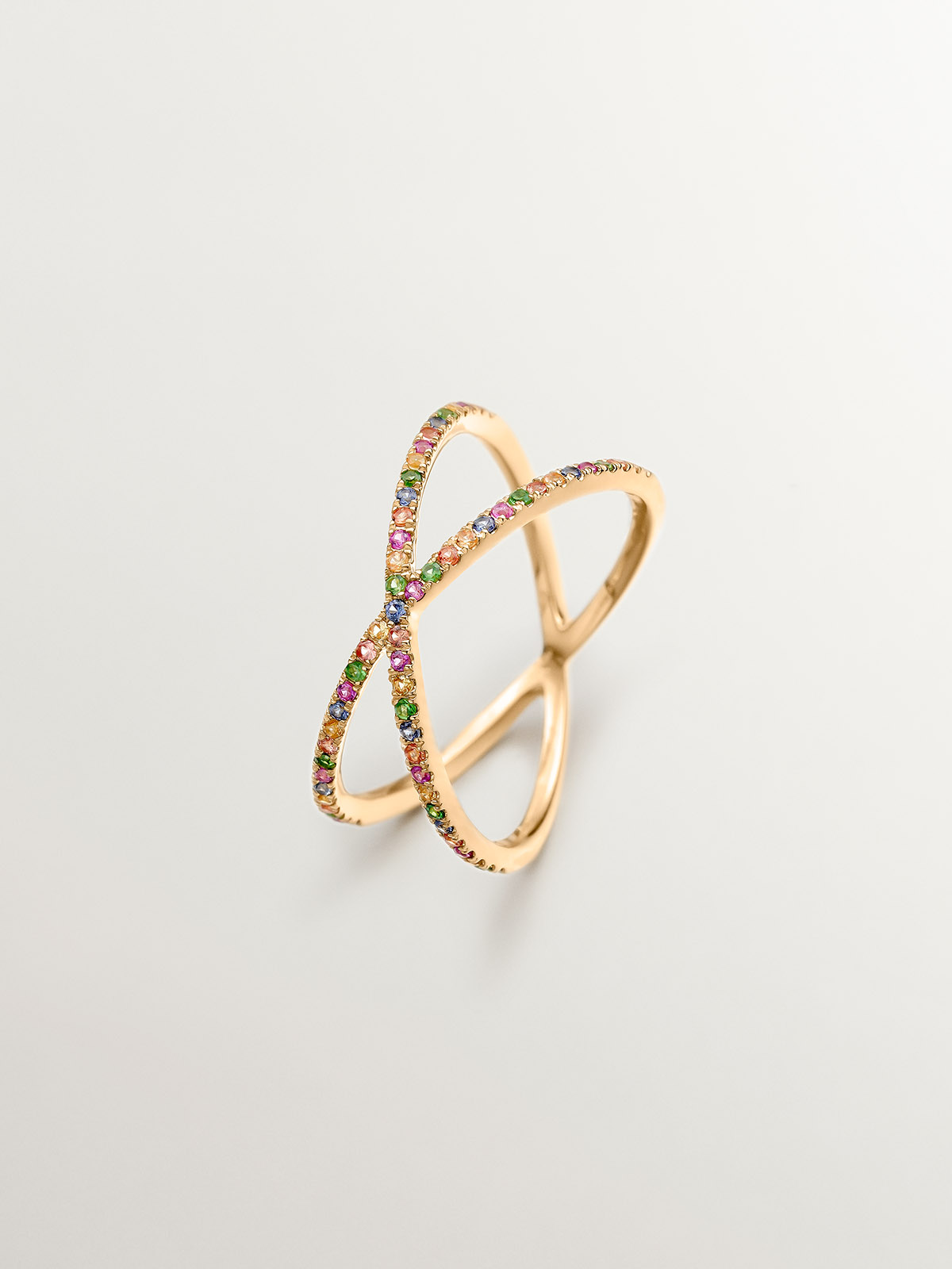 Double crossed 9K yellow gold ring with tsavorites and multicolor sapphires.