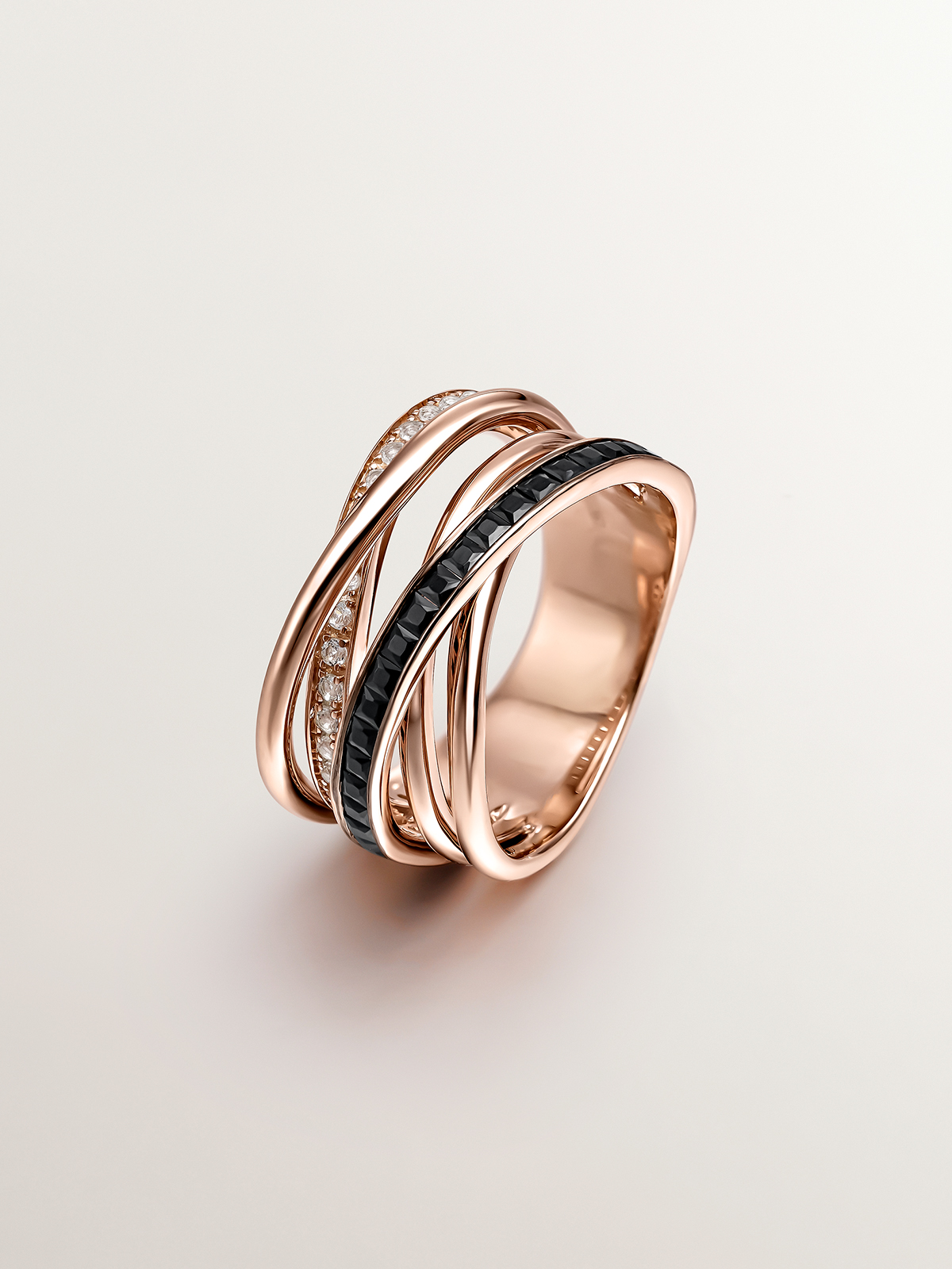 Multi-arm 925 silver ring bathed in 18K rose gold with white topaz and black spinel.