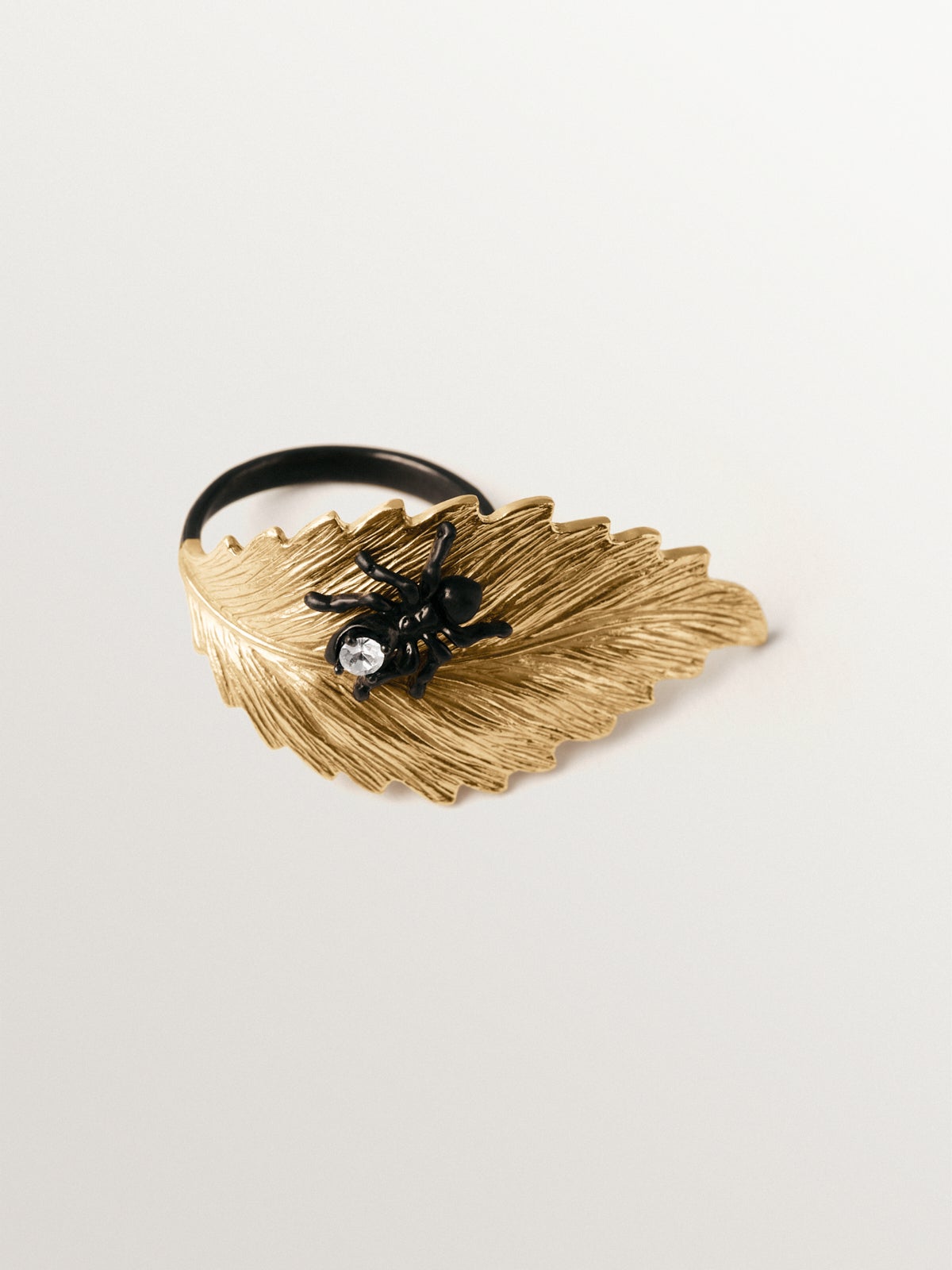 Anillo bañado en oro amarillo con cristales y forma de hoja