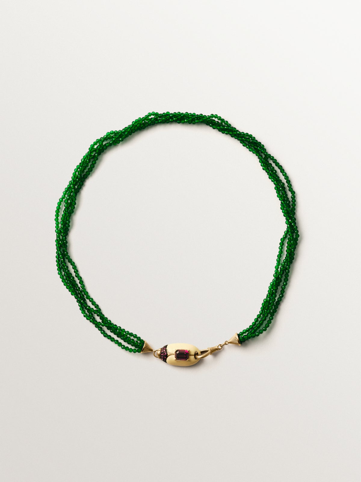 Yellow gold-plated necklace with green crystal beads and beetle shape with purple crystals