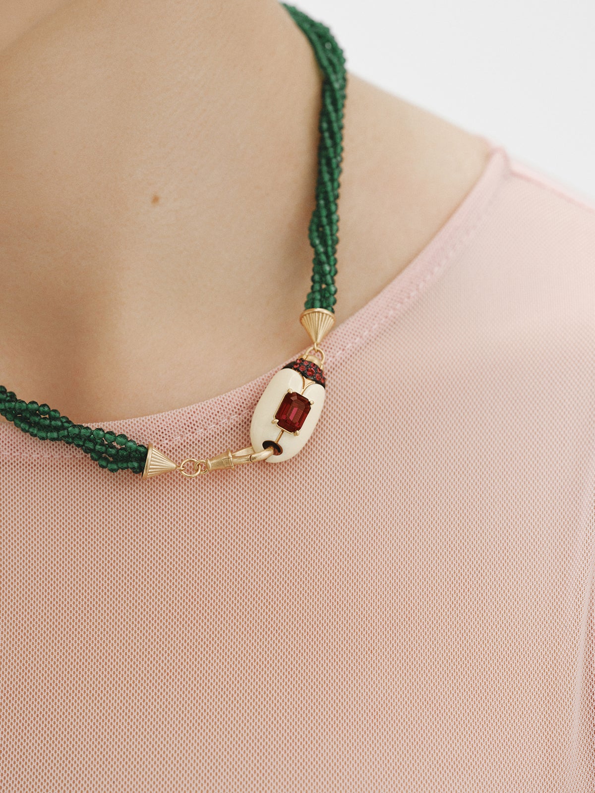 Yellow gold-plated necklace with green crystal beads and beetle shape with purple crystals