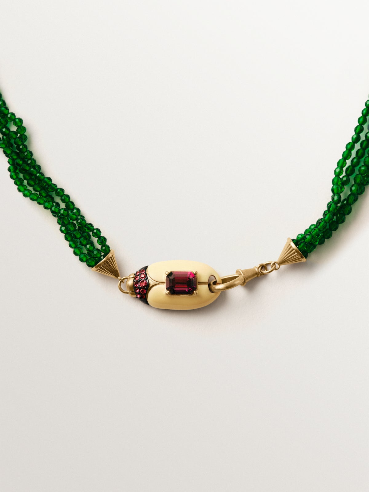 Yellow gold-plated necklace with green crystal beads and beetle shape with purple crystals