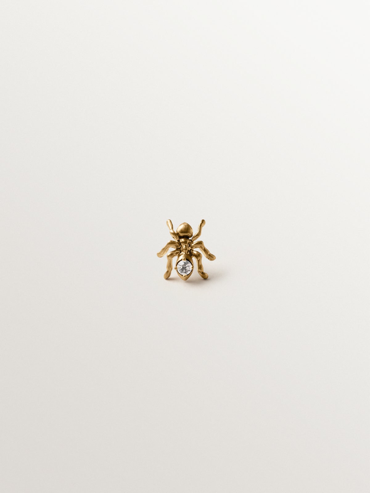 Pin bañado en oro amarillo con cristal y forma de hormiga