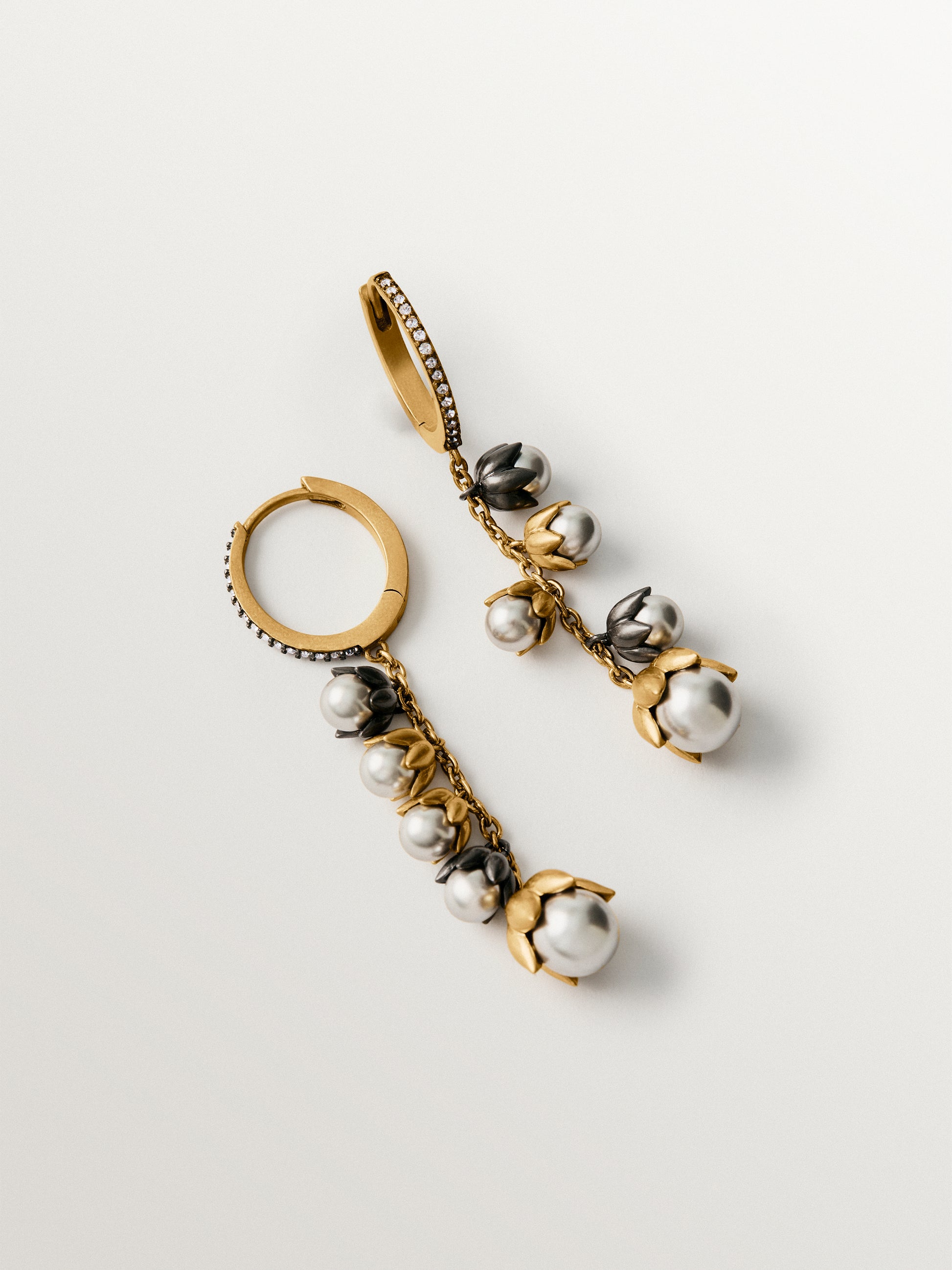 Pendientes bicolor bañados en oro amarillo con acabado gunmetal, perlas grises, cristales y forma de flor