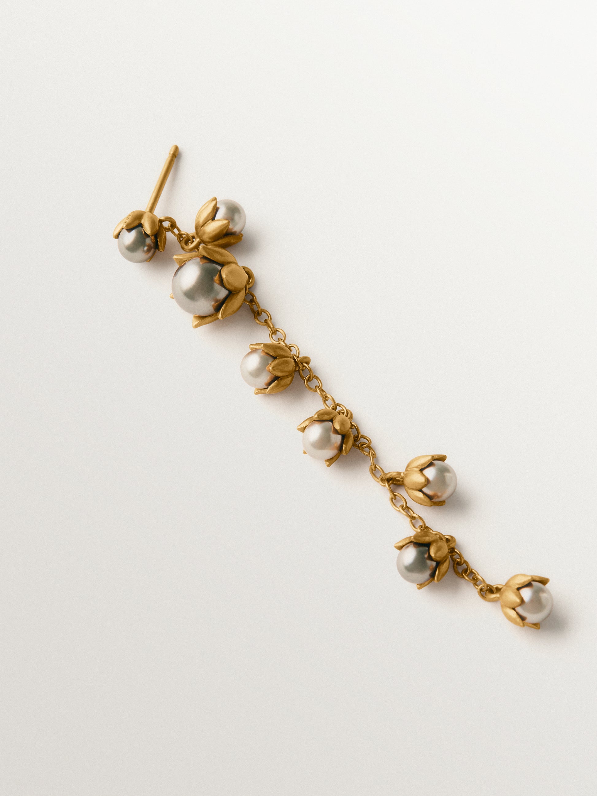 Pendiente individual bicolor bañado en oro amarillo con acabado gunmetal, perlas grises y motivos florales