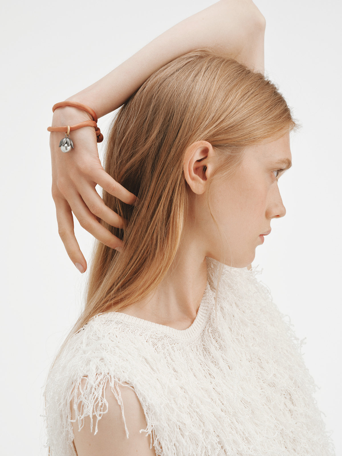 Charm bicolor bañado en oro amarillo con acabado gumetal, perla gris y forma de flor