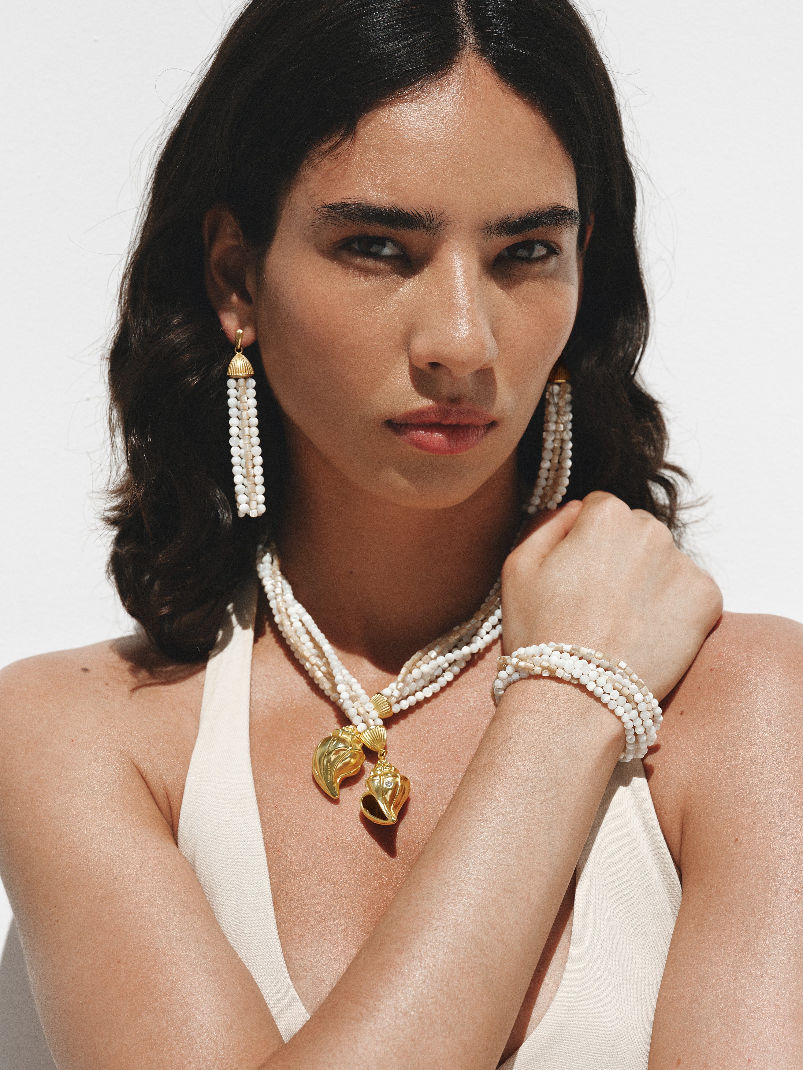 Pulsera bañada en oro amarillo con bolitas blancas y crema