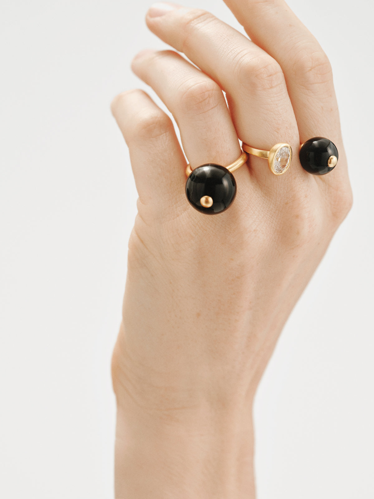 Anillo abierto bañado en oro amarillo con efecto cepillado, ágata negra, topacio y motivo de esferas