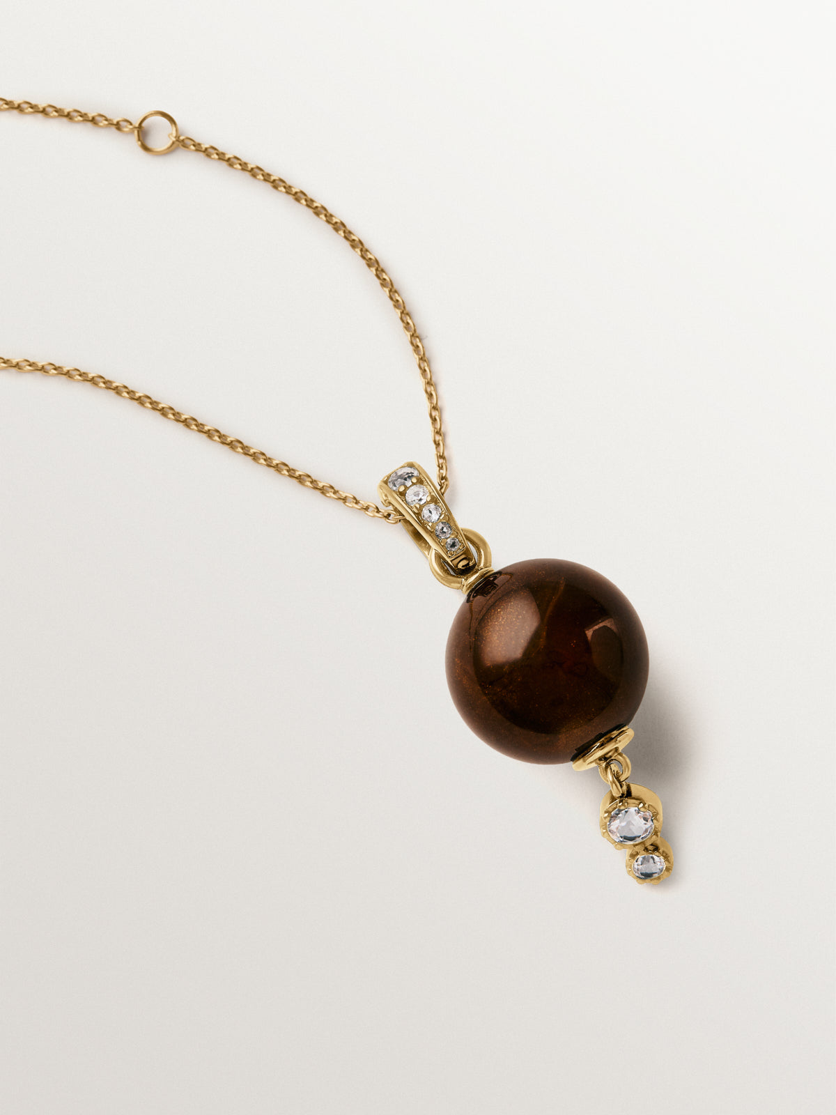 18K yellow gold-plated charm with brown resin, crystals and sphere motif