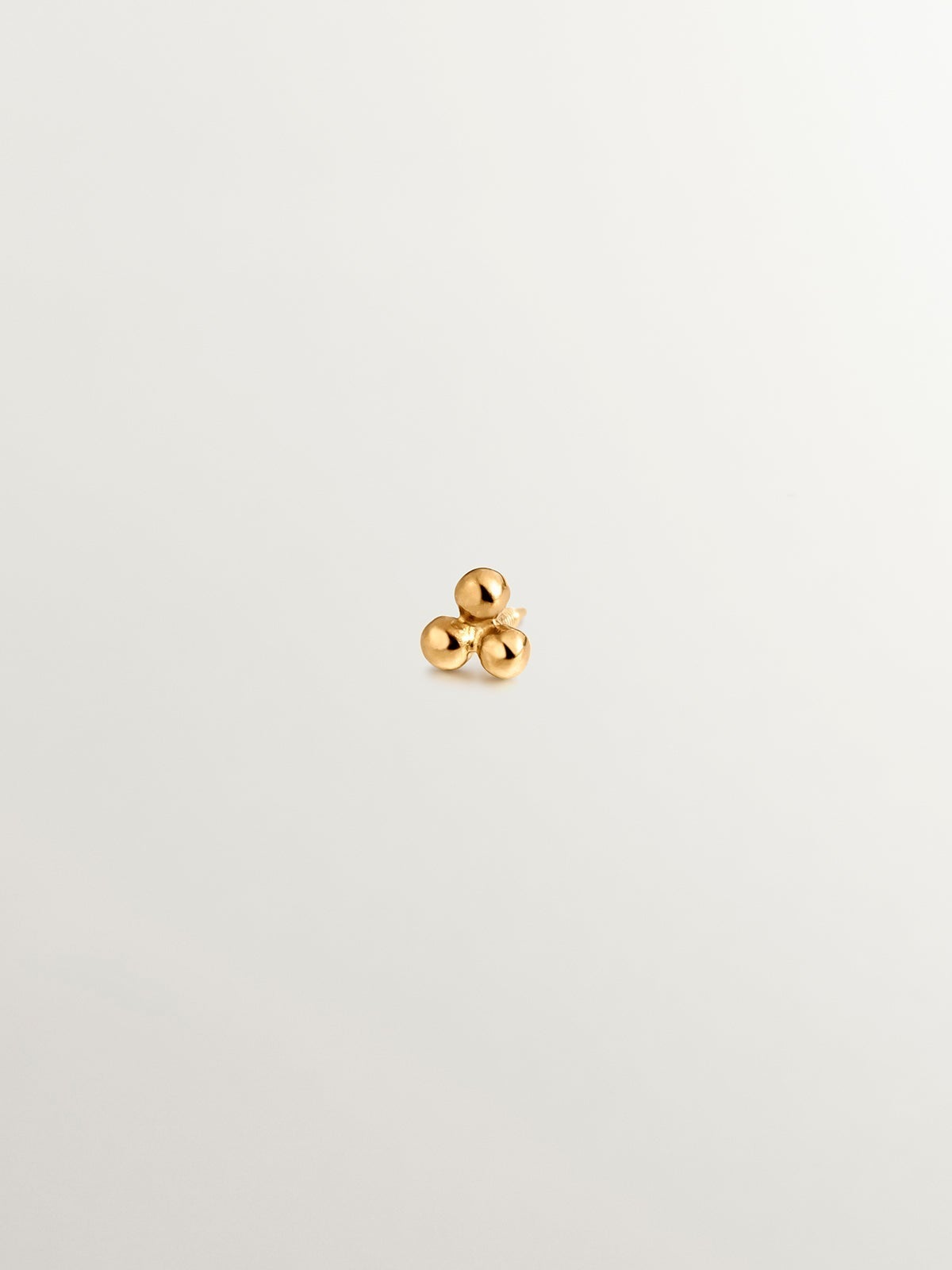 Piercing de oro amarillo de 18K con triple bolita