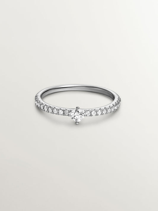 Anillo de oro blanco de 18K con brazo de diamantes y diamante central 0,23 cts