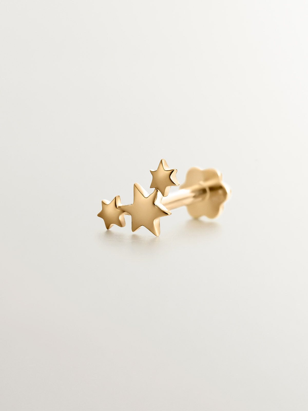 Piercing de oro amarillo de 18K con triple estrella