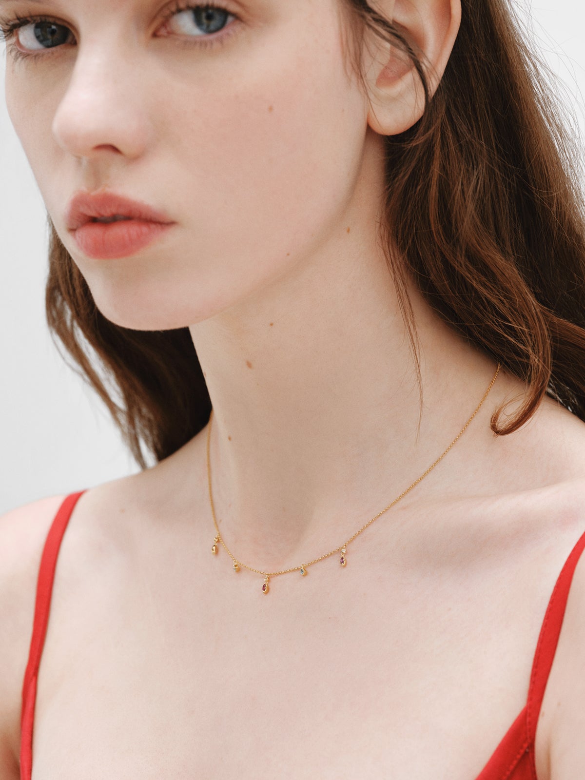 925 Silver necklace coated in 18K yellow gold with rhodolites and topazes.