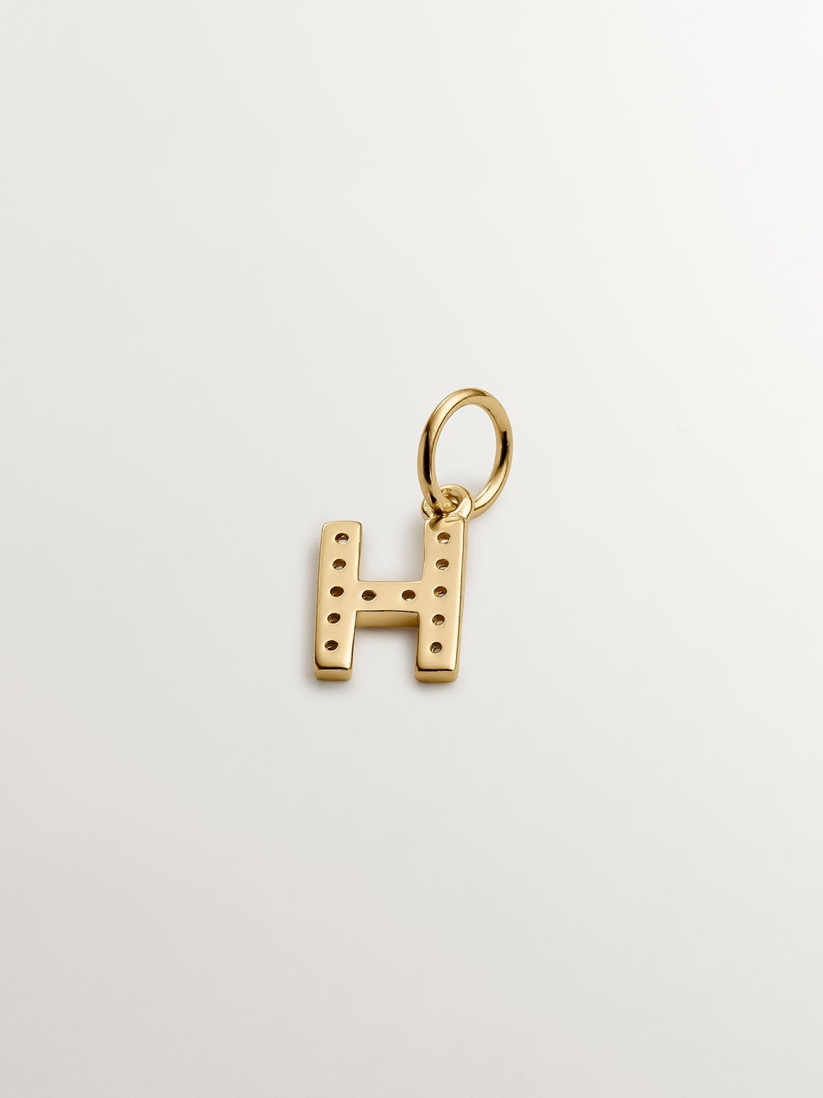 Charm de plata 925 bañada en oro amarillo de 18K y topacios blancos inicial H