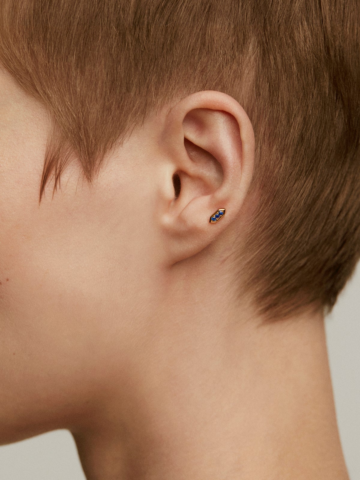 Piercing hexagonal de oro amarillo de 18k con zafiros azules