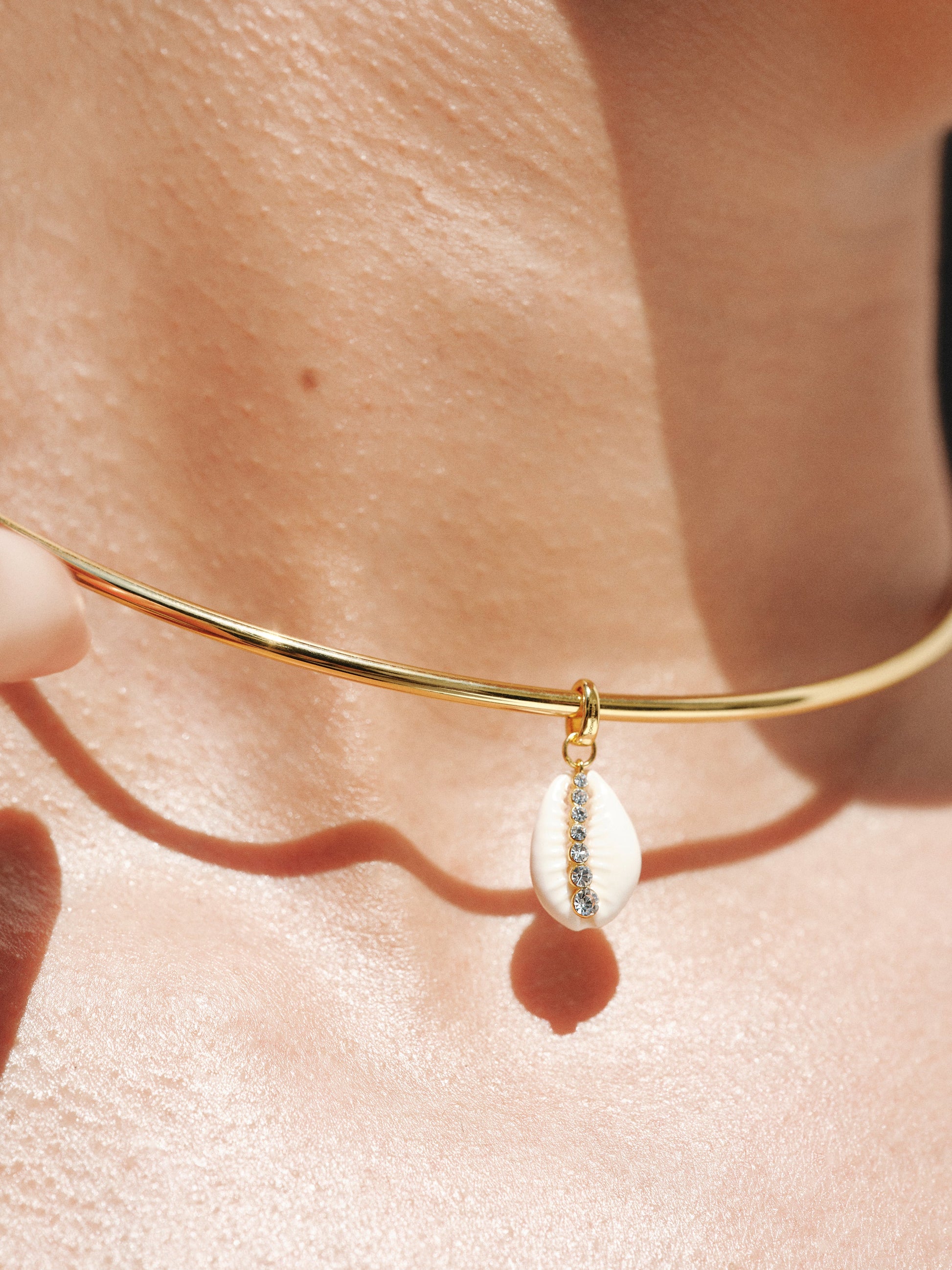 Charm de plata 925 bañada en oro amarillo de 18K con concha blanca y cristales