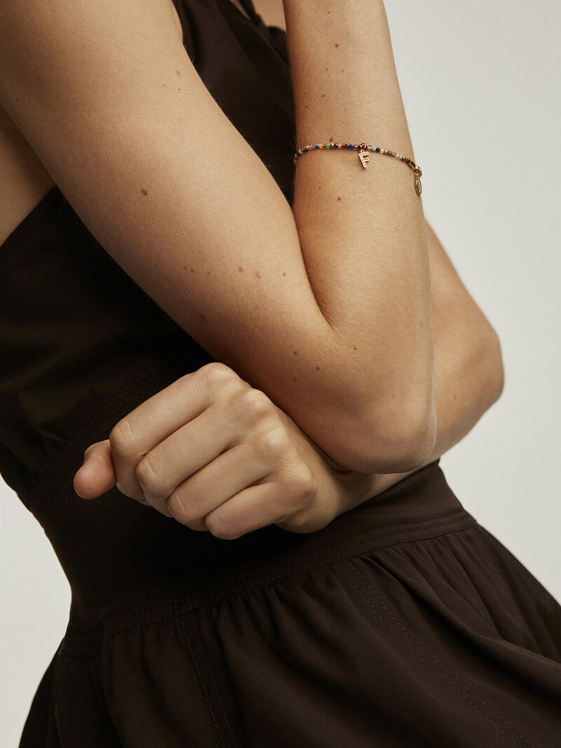 F initial charm made of 925 silver, bathed in 18K yellow gold with white topazes. image number 1