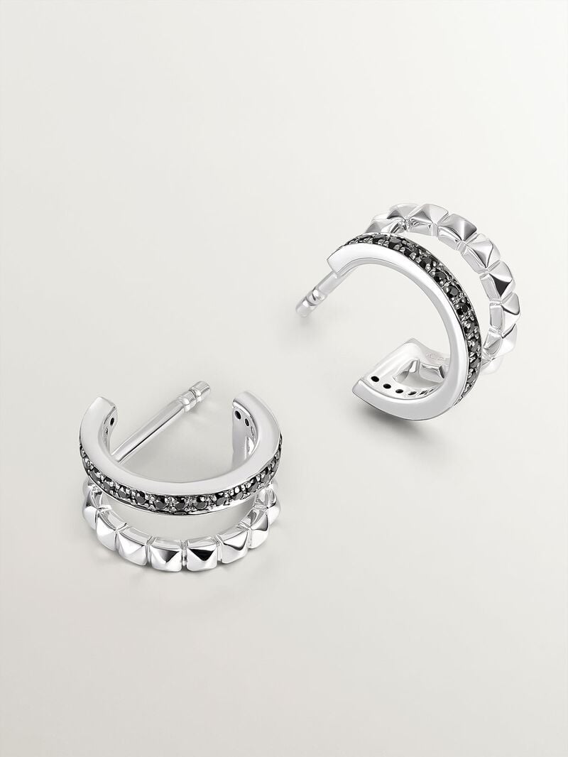 Small double hoop earrings made of 925 silver with embossed detailing and black spinels. image number 2