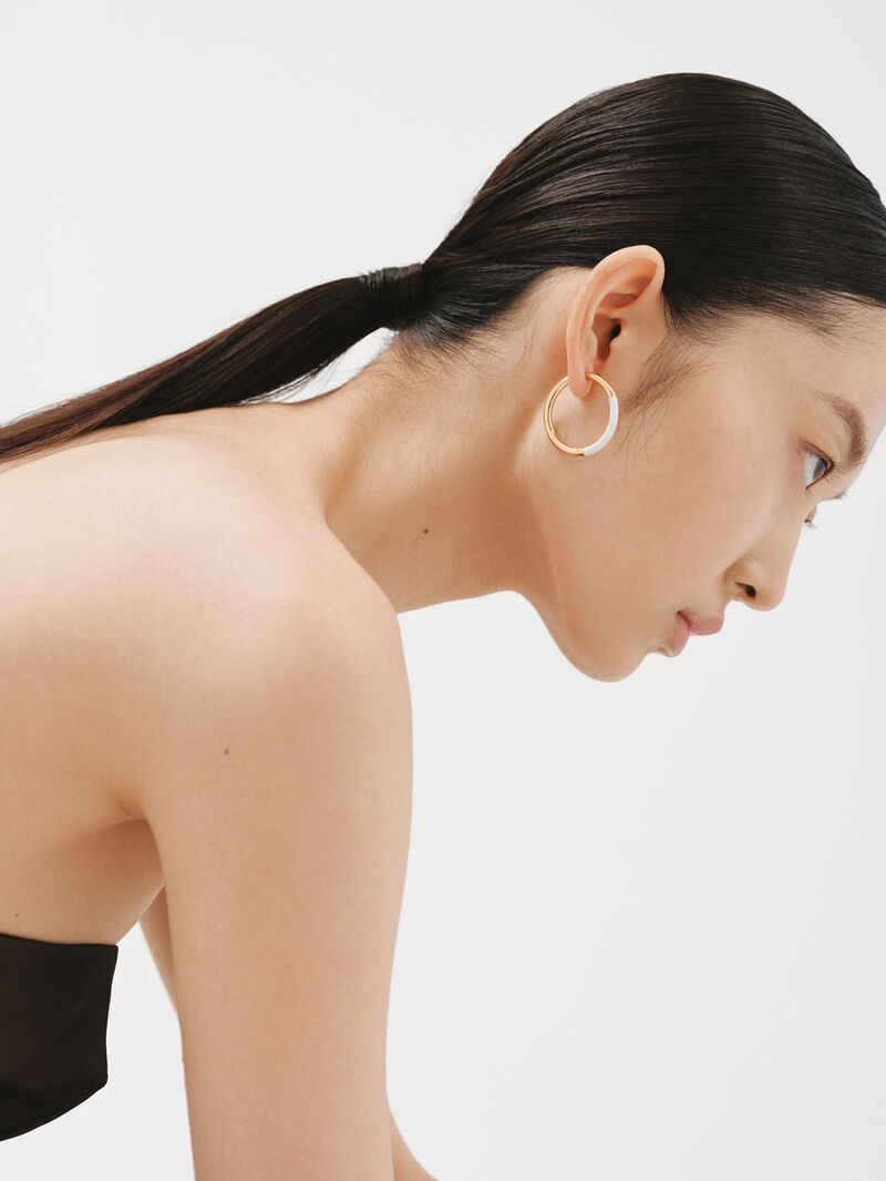 Large hoop earrings made of 925 silver coated in 18K yellow gold with white enamel. image number 1