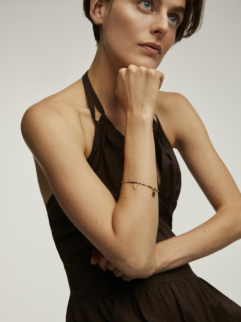 F initial charm made of 925 silver, bathed in 18K yellow gold with white topazes. image number 3