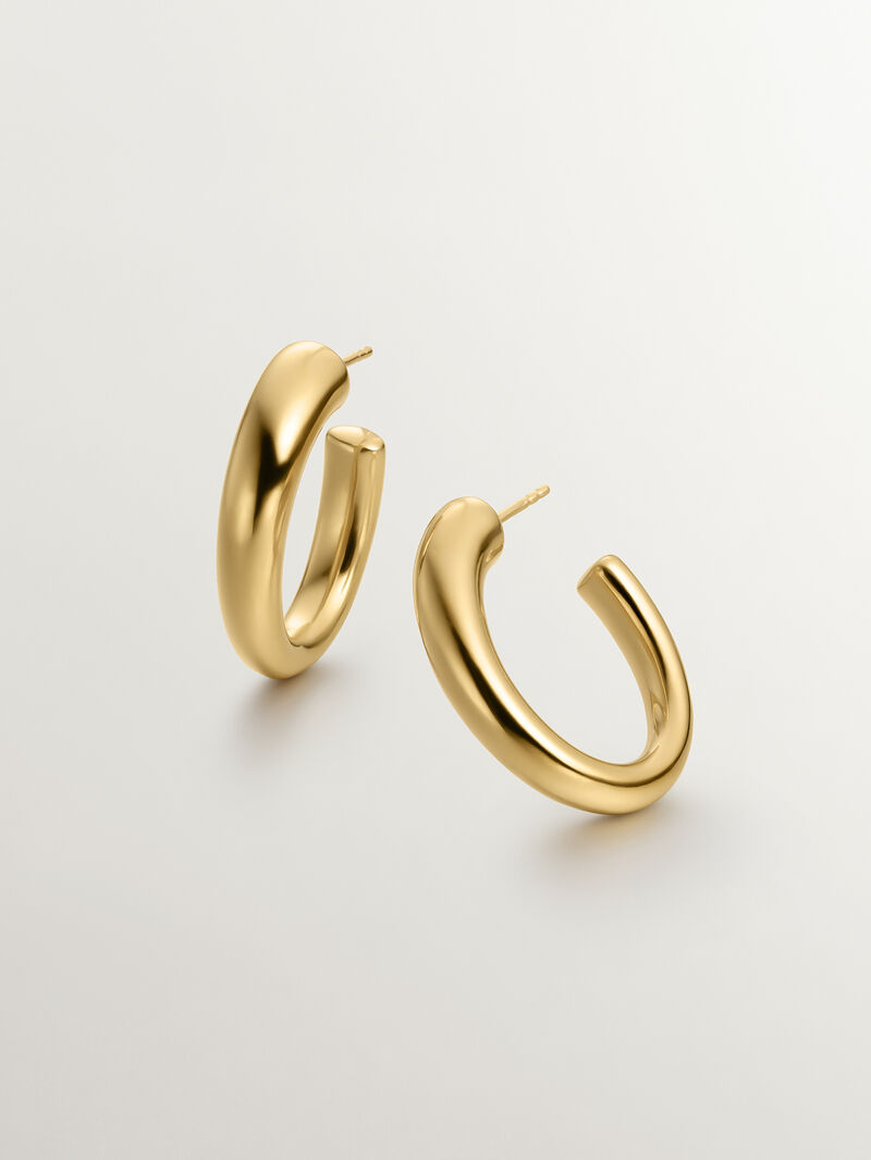 Large and thick hoop earrings made of 925 silver, bathed in 18K yellow gold, with an oval shape. image number 4