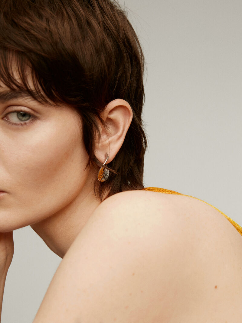 Medium-sized 925 silver hoop earrings with embossed and irregular shape image number 3