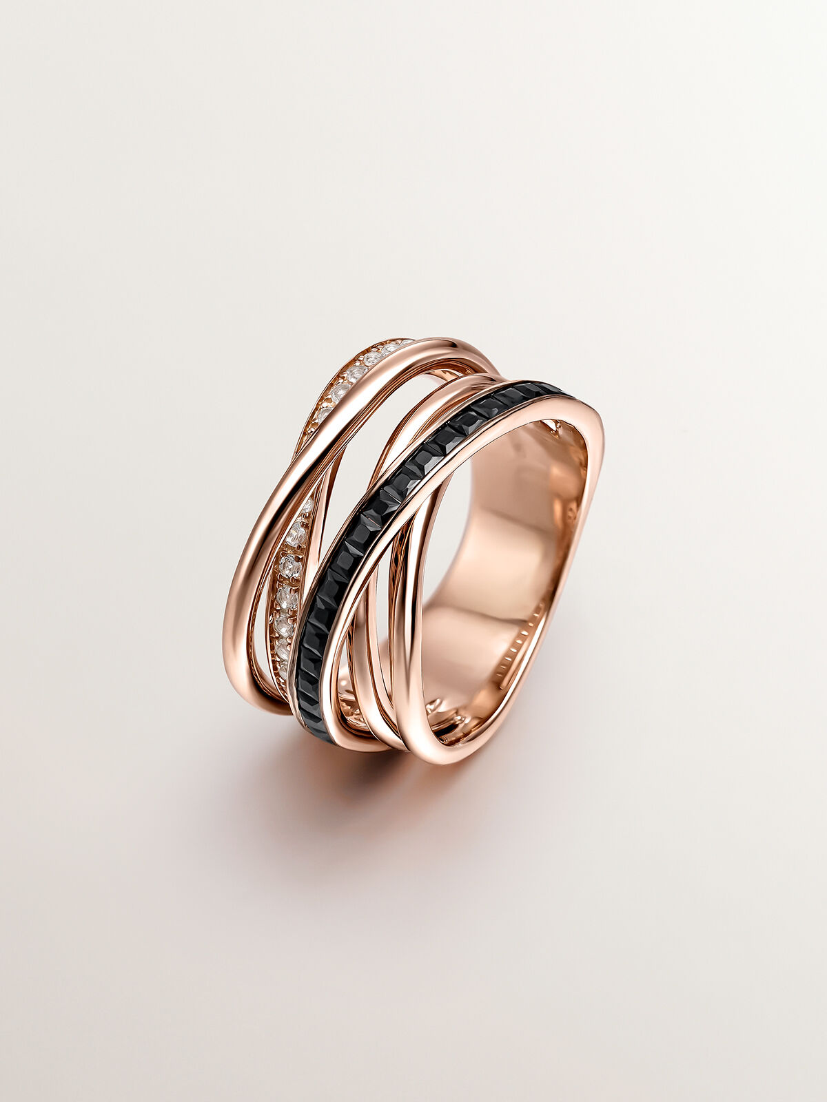 Anillo multibrazo de plata 925 banada en oro rosa de 18K con topacios blancos y espinelas negras