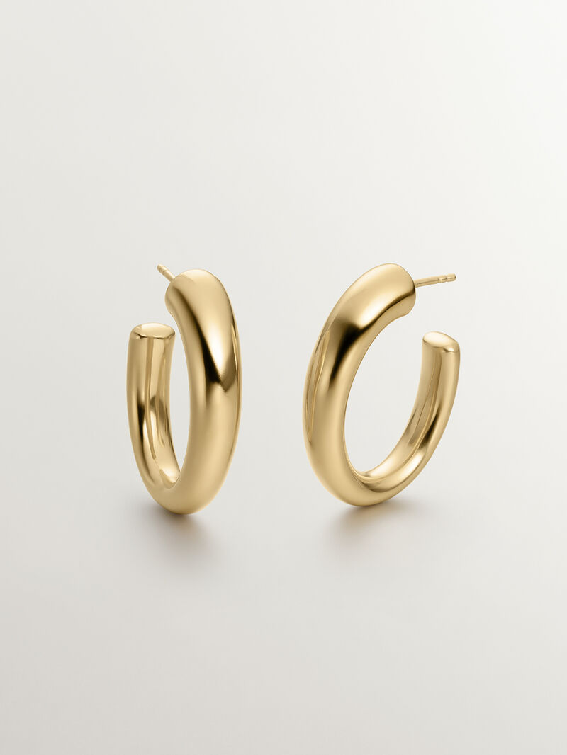 Large and thick hoop earrings made of 925 silver, bathed in 18K yellow gold, with an oval shape. image number 0