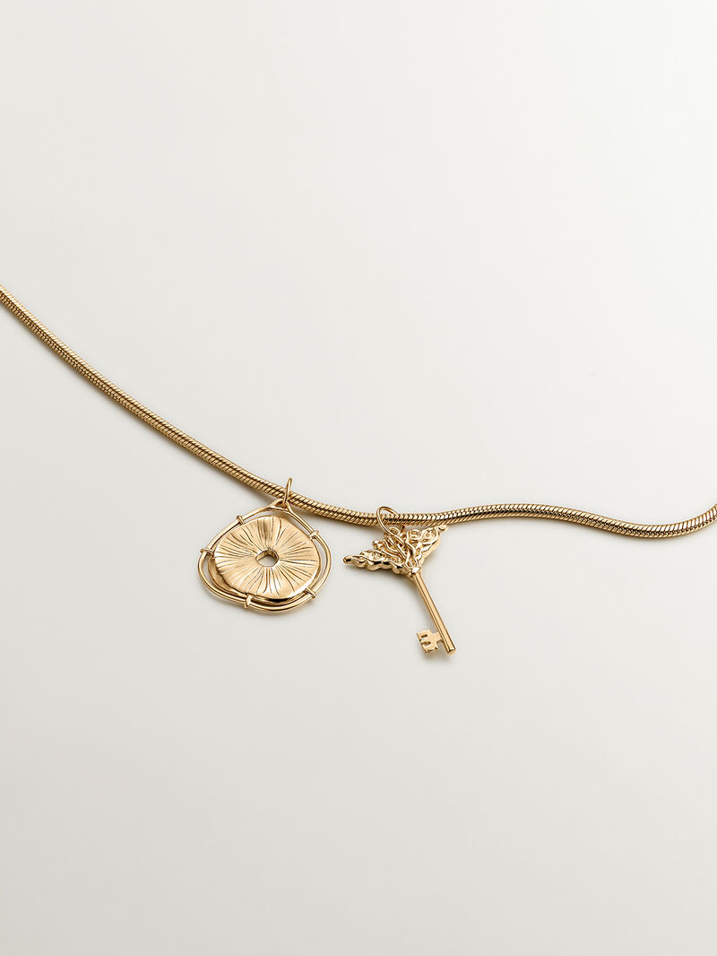 925 Silver charm, gold-plated in 18K yellow gold, with an irregular medallion shape and white topaz stones. image number 4