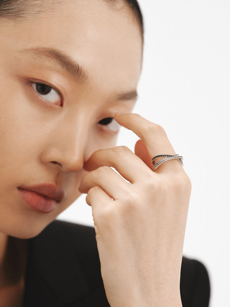 Triple crossed ring made of 925 silver plated in 18K yellow gold with white topazes and black spinels. image number 1