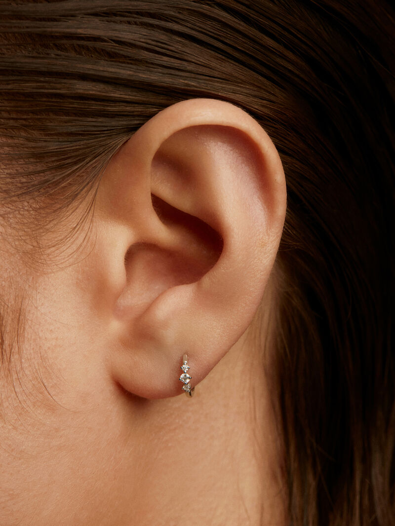 Small individual 18K white gold hoop earring with triple diamond. image number 1