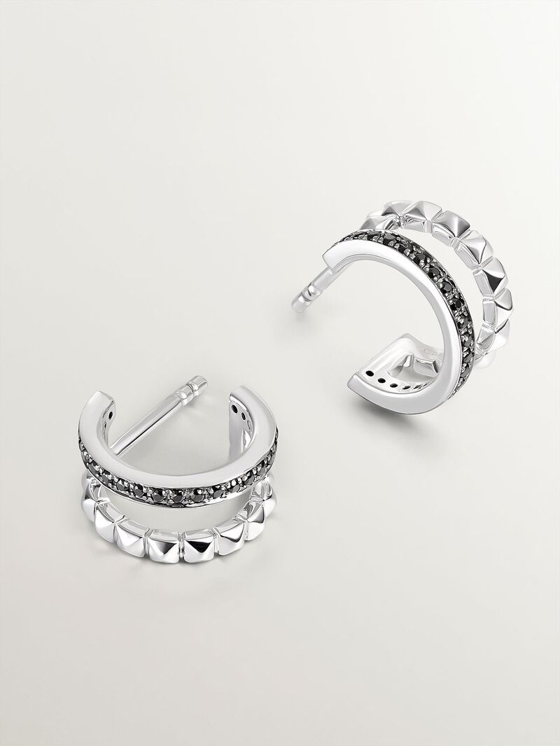 Small double hoop earrings made of 925 silver with embossed detailing and black spinels. image number 2