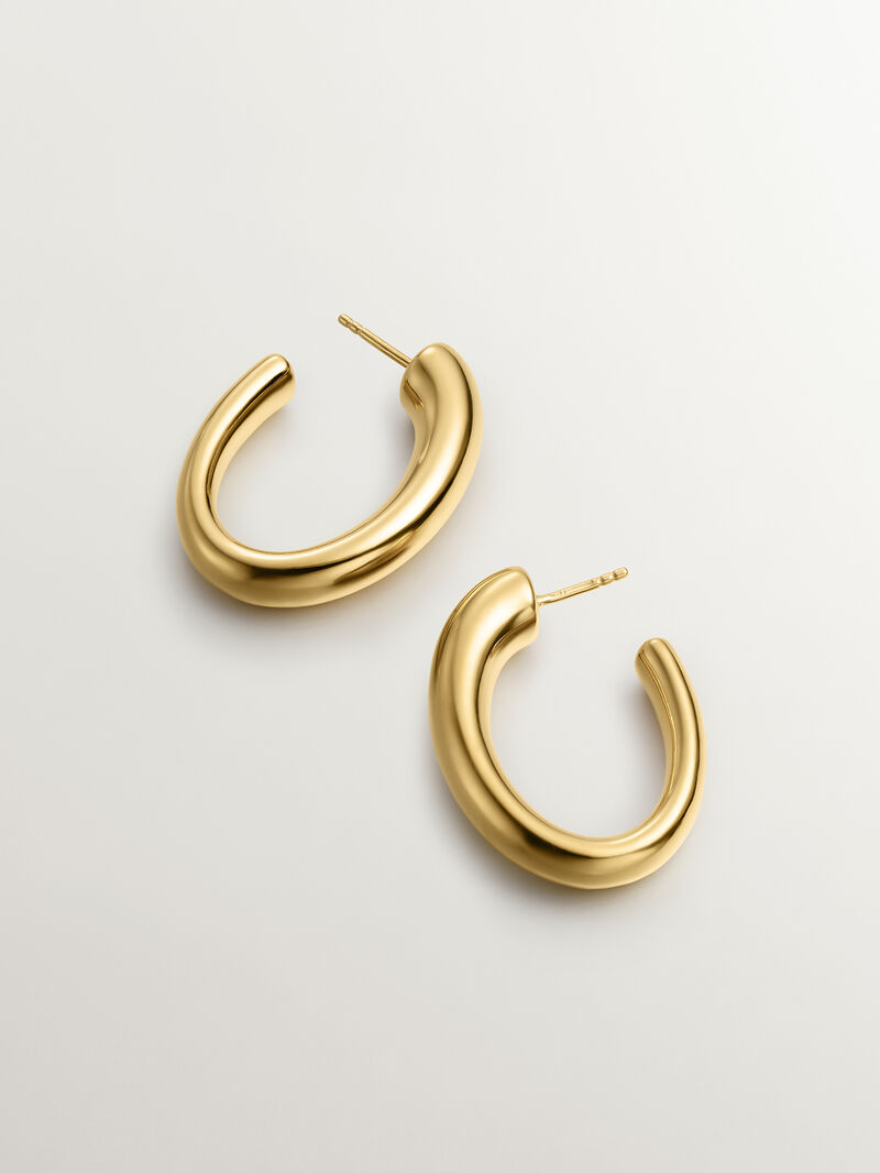 Large and thick hoop earrings made of 925 silver, bathed in 18K yellow gold, with an oval shape. image number 2