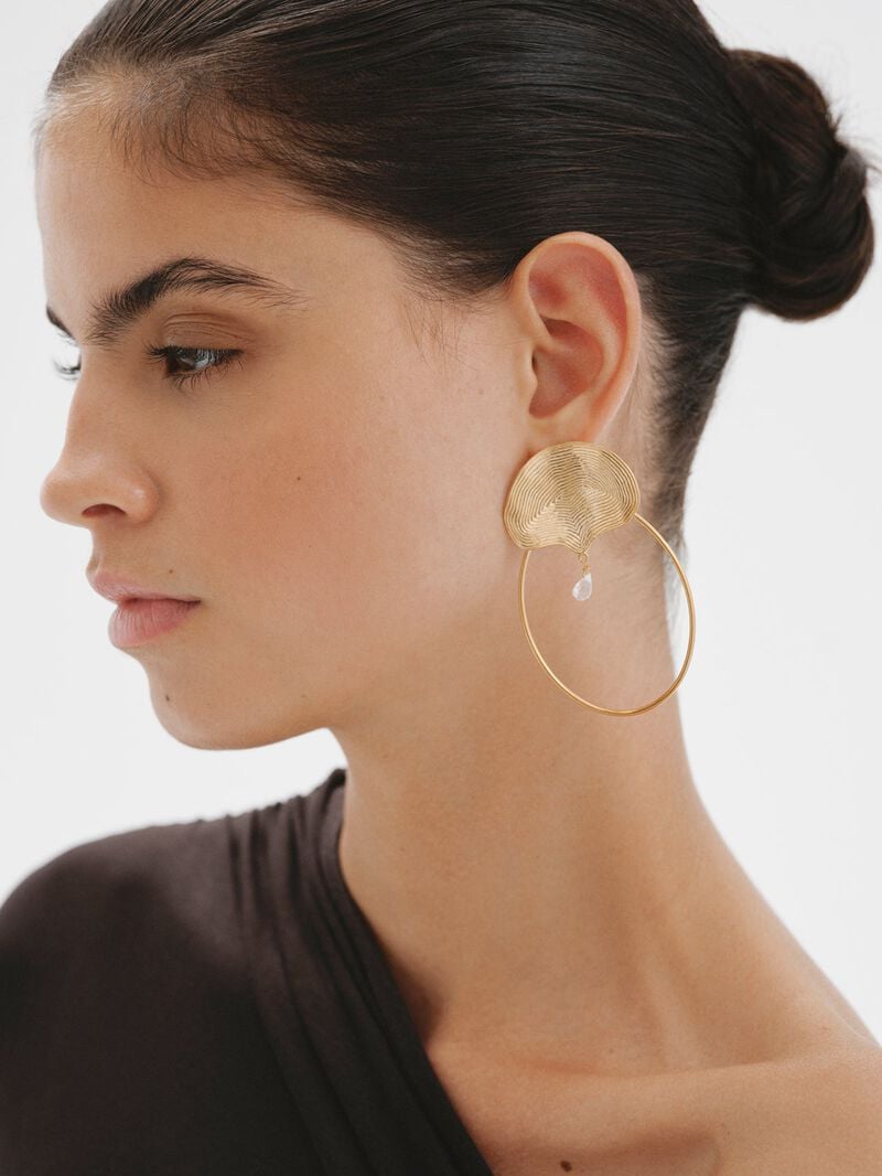 Large hoop earrings made of 925 silver, bathed in 18K yellow gold with embossing and white topaz. image number 1