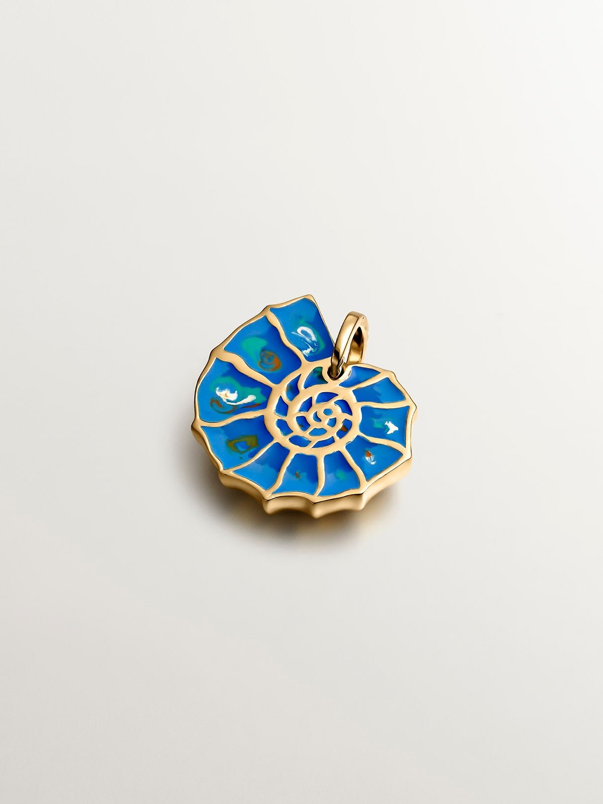 925 silver charm plated in 18K yellow gold with blue enameling and white topazes shaped like a shell.