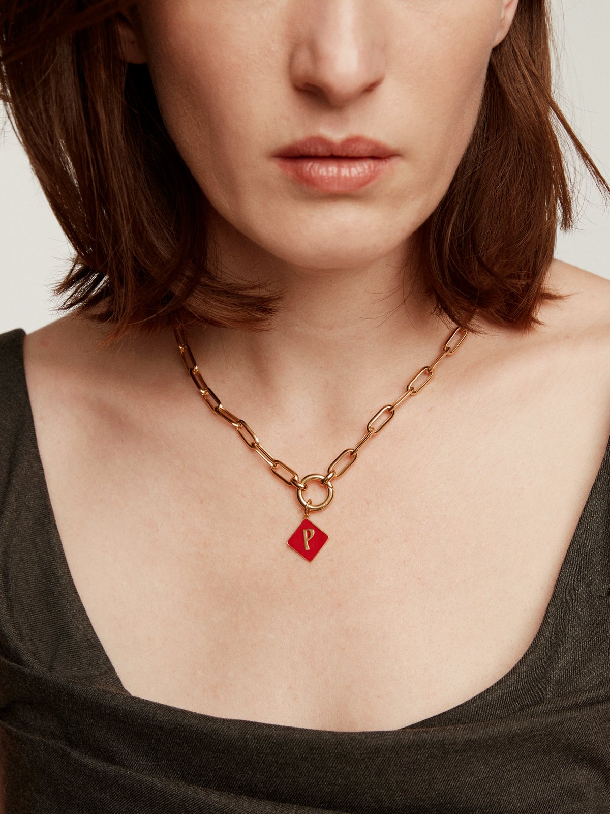 18K yellow gold plated 925 sterling silver charm with initial P and red enamel in diamond shape