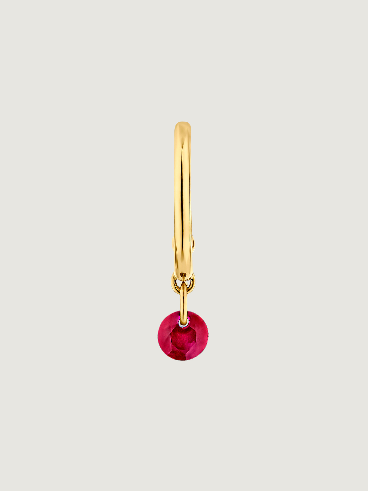 Individual 18K yellow gold hoop earring with ruby.