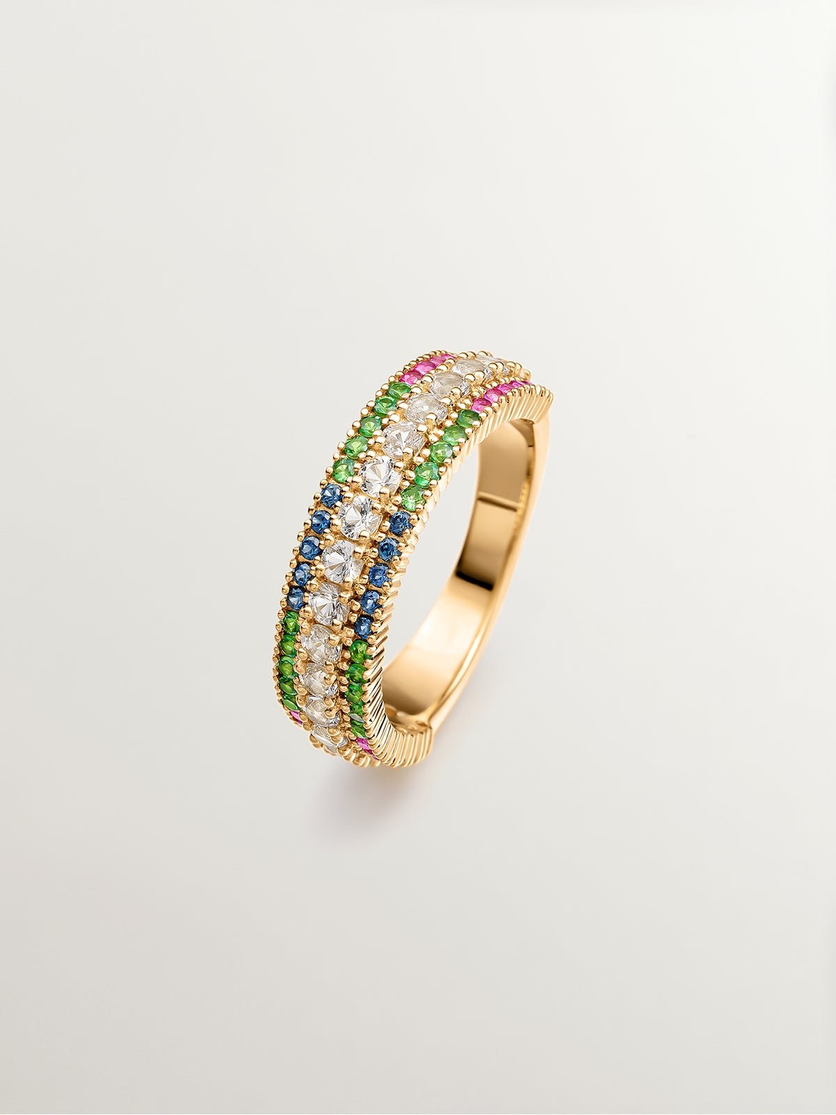 925 Silver ring bathed in 18K yellow gold with tsavorites, topaz, and multicolored sapphires.