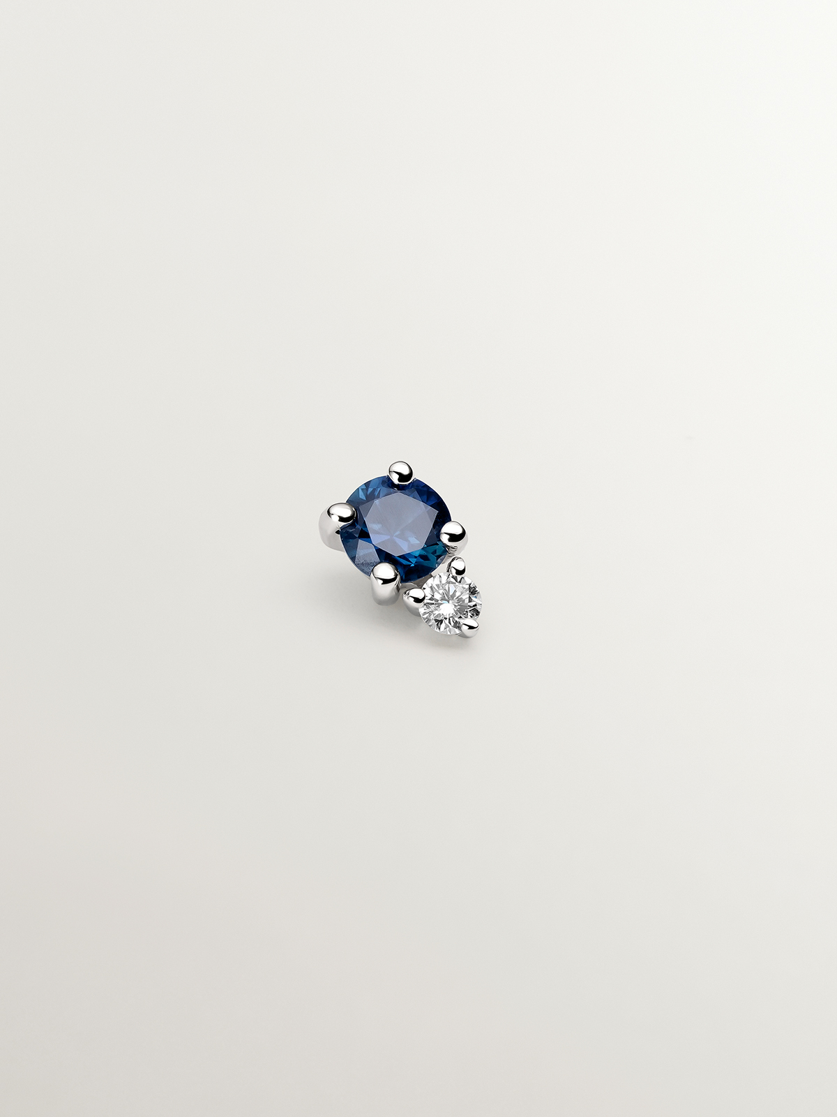 Individual 18K white gold earring with sapphire and diamond.