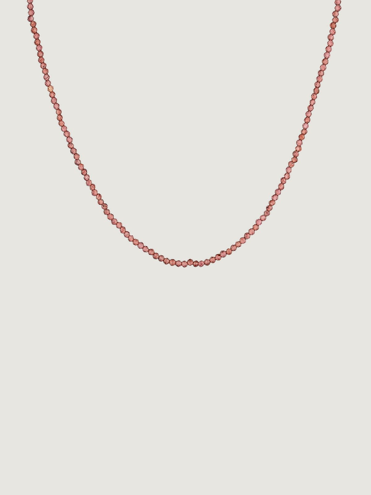 925 Silver necklace bathed in 18K yellow gold with pink rhodolite beads.