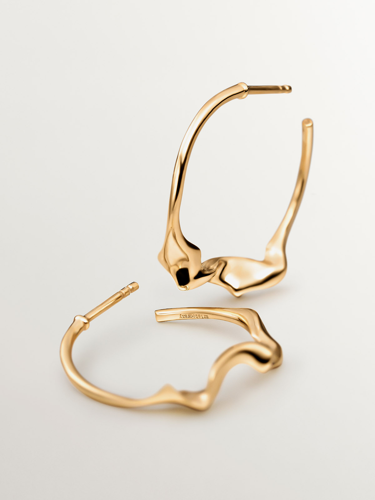 Large irregular hoop earrings made of 925 silver covered in 18K yellow gold