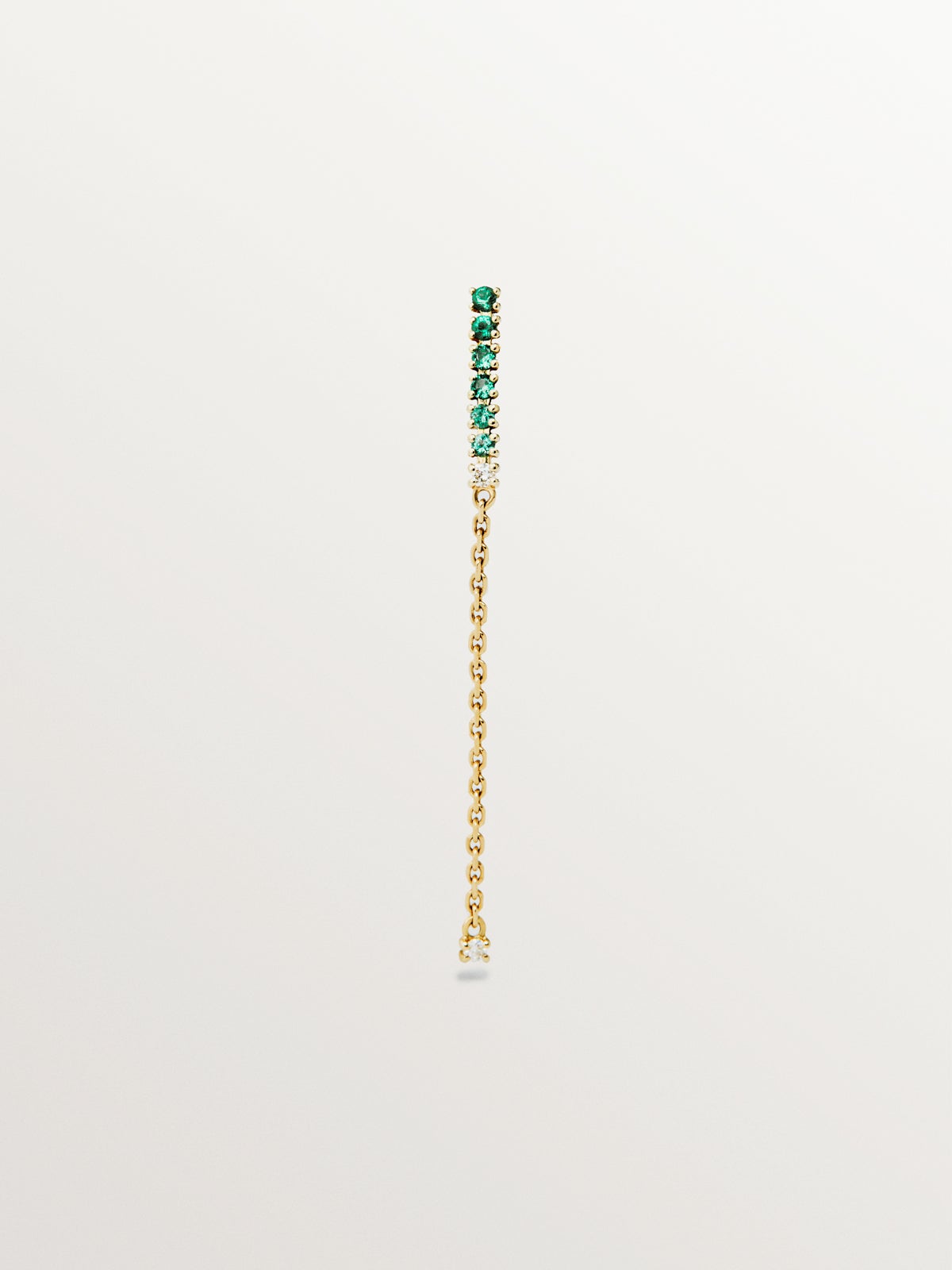 Long individual 9K yellow gold earring with emeralds and diamonds